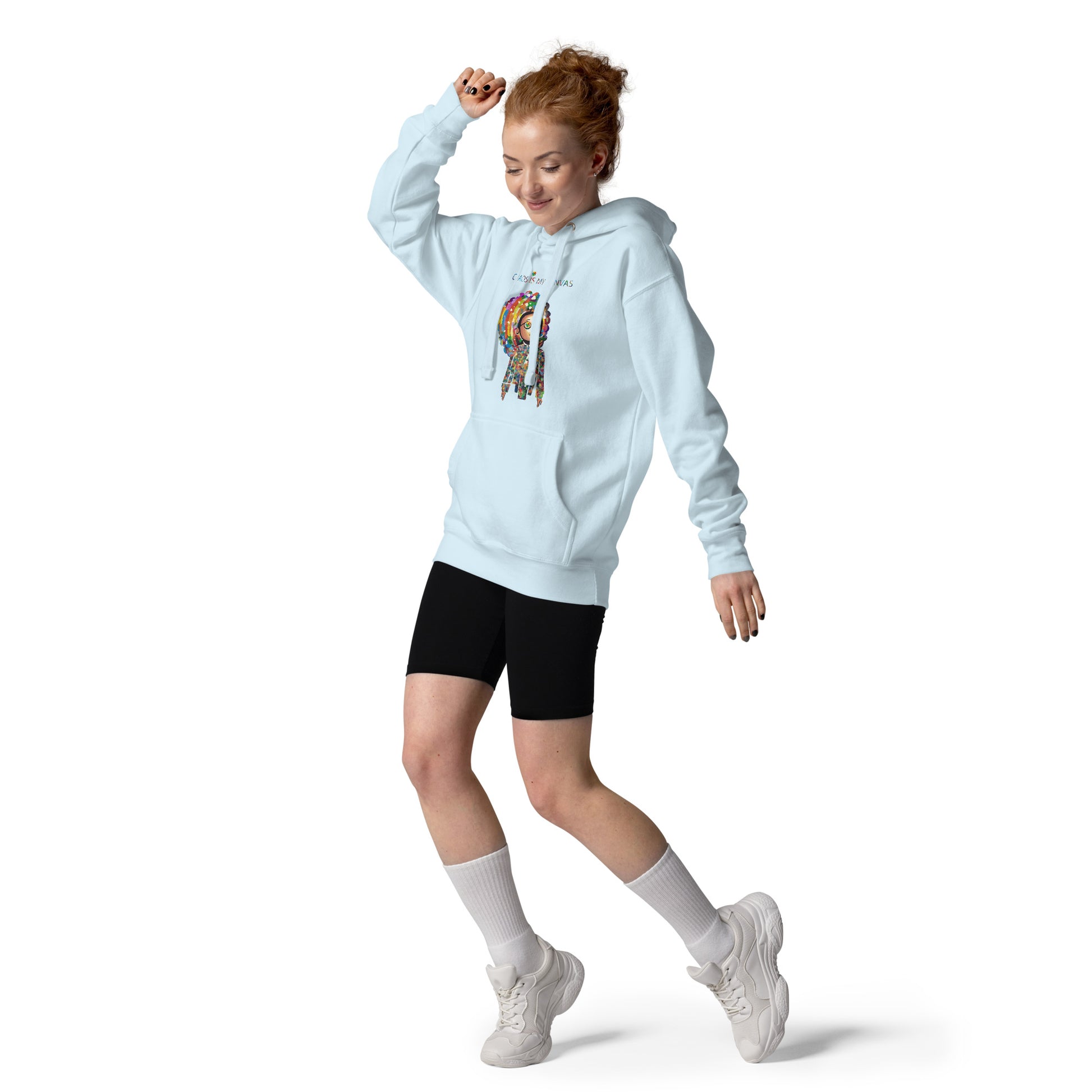 Person wearing a light blue unisex hoodie featuring colorful rainbow-inspired artwork and a cheerful motivational design.