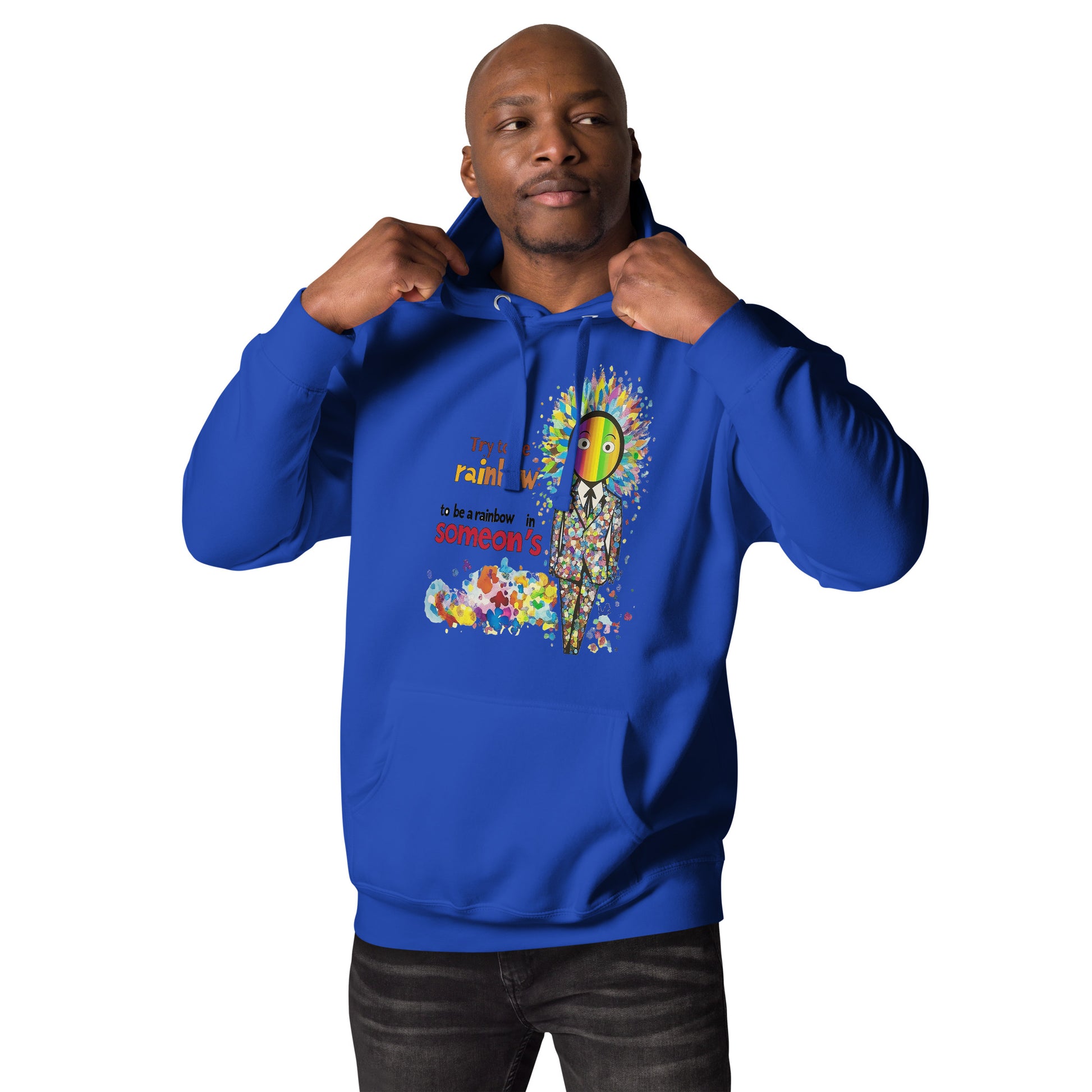 Man wearing a blue unisex hoodie featuring a colorful Be a Rainbow graphic with vibrant rainbow artwork, uplifting message, and playful pop art details.