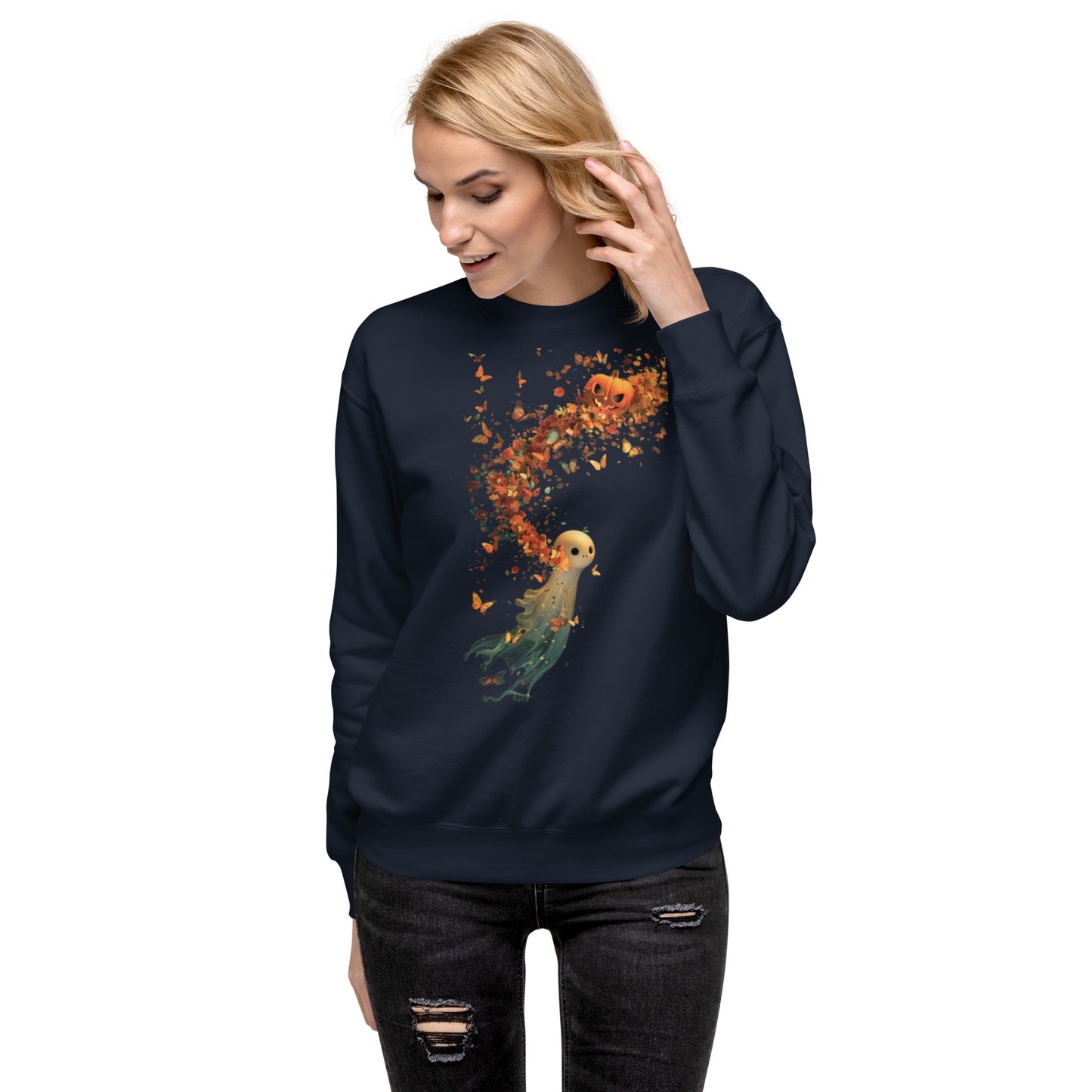 Woman in a navy sweatshirt featuring a spooky pumpkin ghost with autumn leaves.