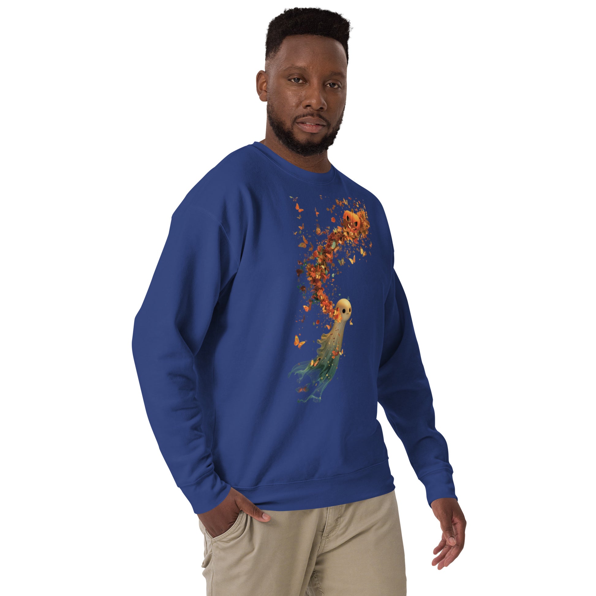 Man in a royal blue sweatshirt with Halloween pumpkin ghost and swirling leaves design.