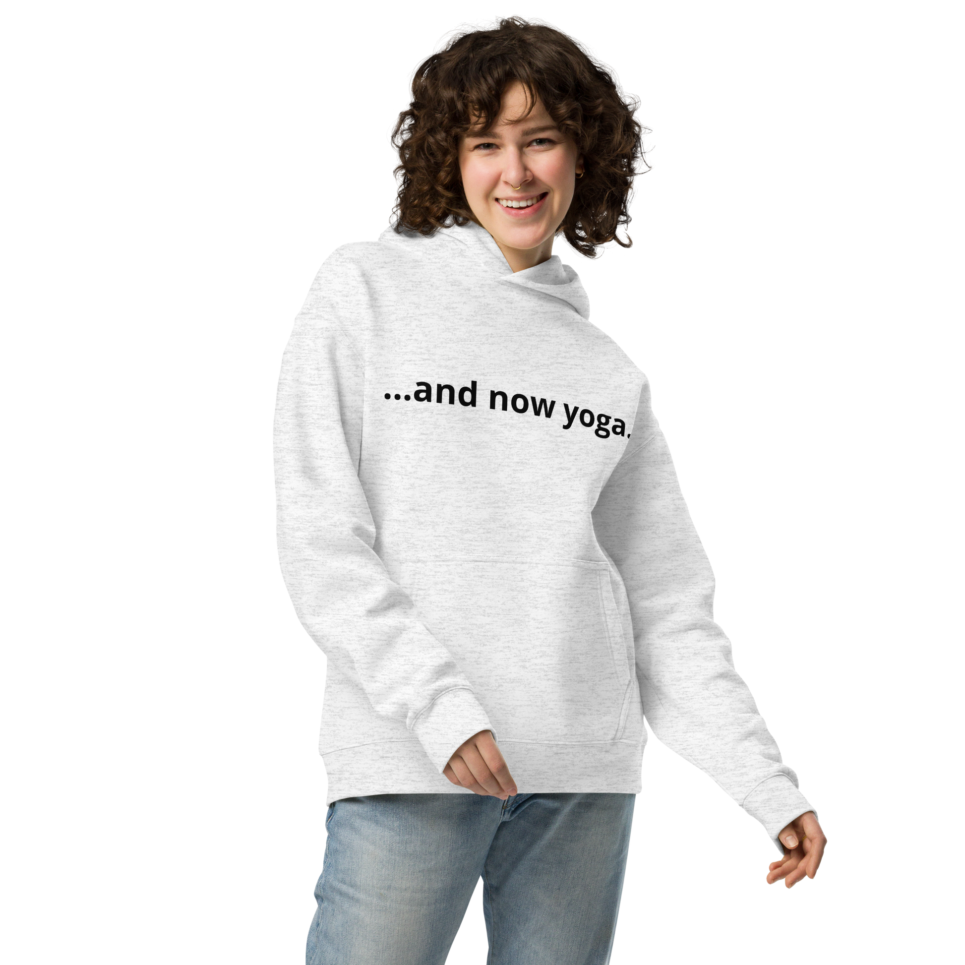 Woman wearing a sport grey oversized yoga hoodie with minimalist “…and now yoga.” quote on the front