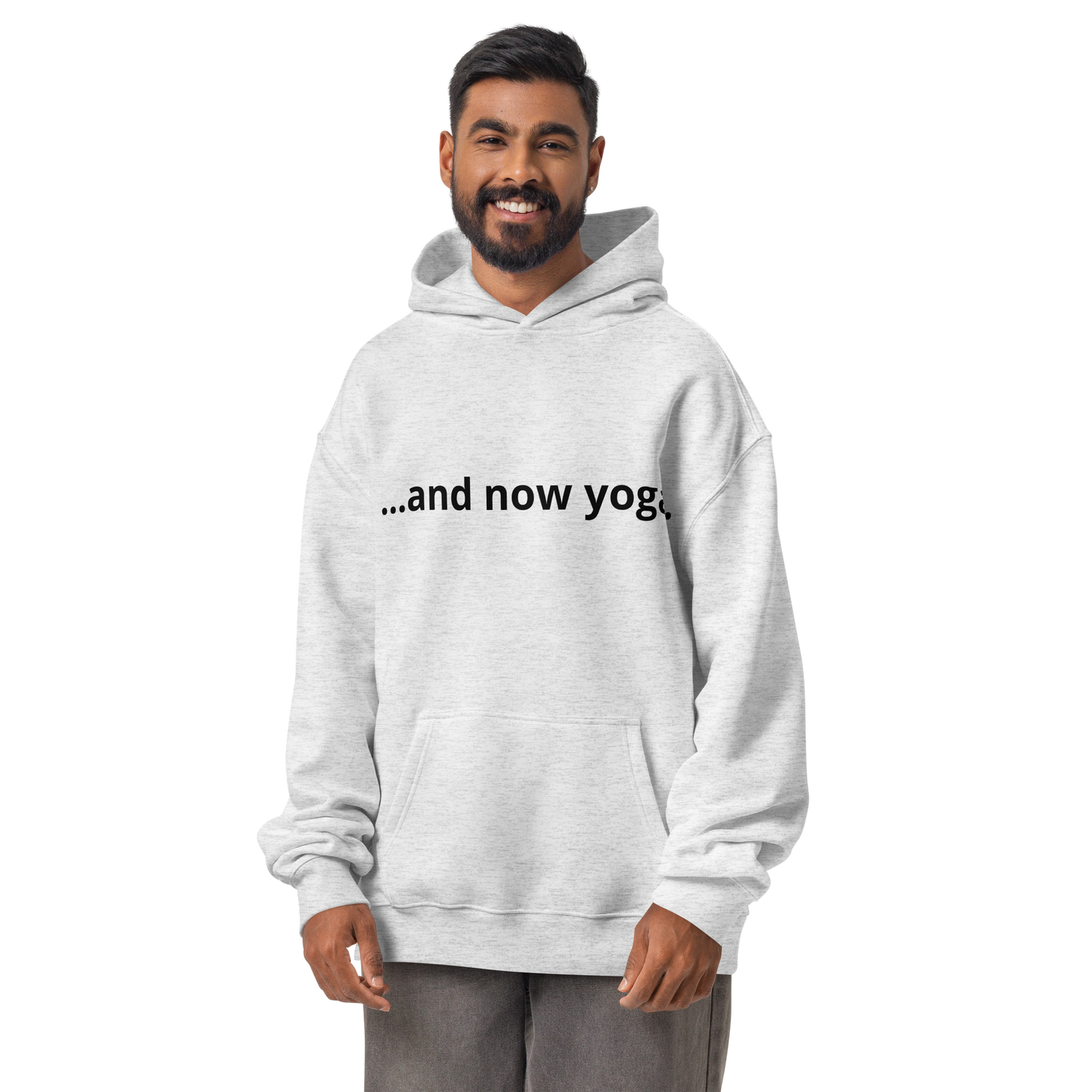 Product mOversized sport grey hoodie with “…and now yoga.” text, combining modern wellness aesthetics and casual comfort.ockup